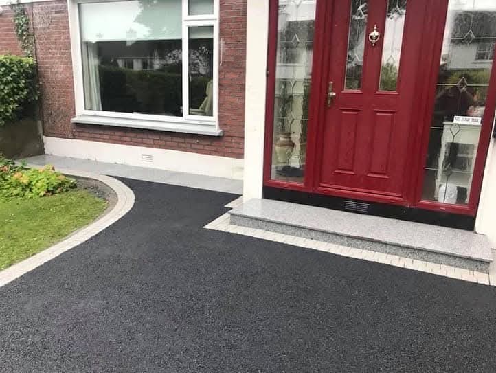Tarmac driveway and granite step at red door entrance, North Dublin